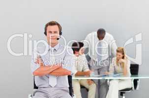 Businessman with a headset on looking at the camera