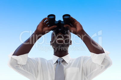 Businessman looking through binoculars