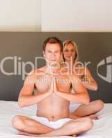 Couple doing exercises on bed