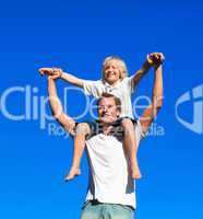 Child sitting on his father's shoulders