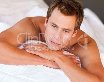 Young man lying in bed