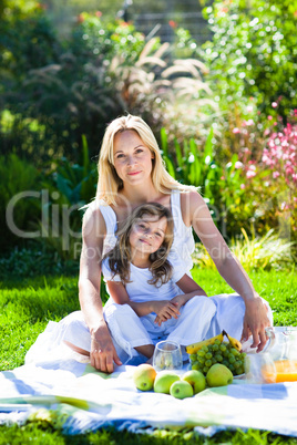 Mother and daughter enjoying a picnic