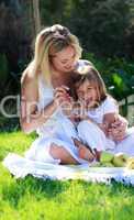 Mother and daughter having fun in a picnic