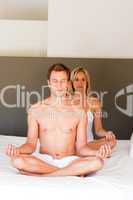Young couple doing mediation buddha exercises