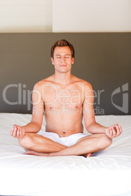 Young boy doing spiritual moves on bed