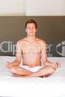 Young boy doing spiritual moves on bed