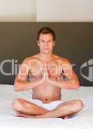 Young boy doing exercises on bed