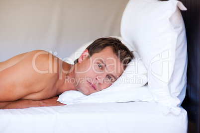Attractive man relaxing on bed