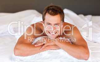 Attractive man smiling on bed