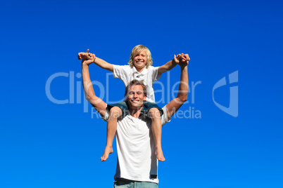 Son sitting on his father's shoulders