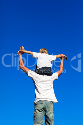 Son sitting on his father's shoulders