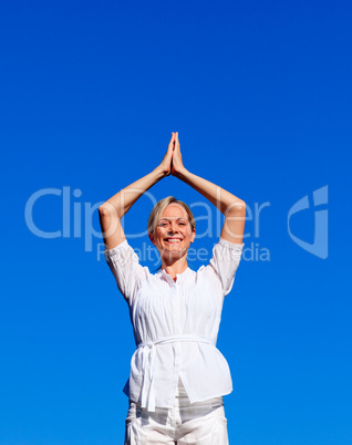 Smiling woman practising yoga