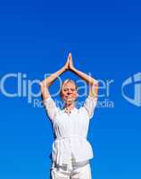 Smiling woman practising yoga