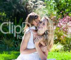 Little girl kissing her mother