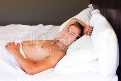 Young man relaxing in bed