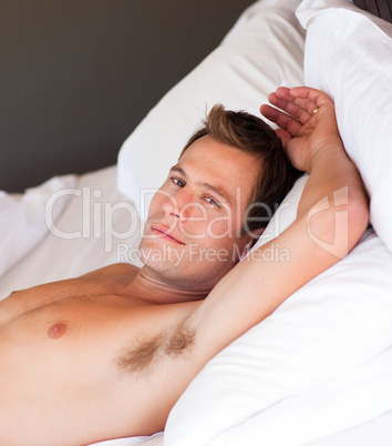 Portrait of a young man relaxing in bed