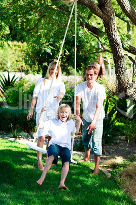 Father, mother and son swinging