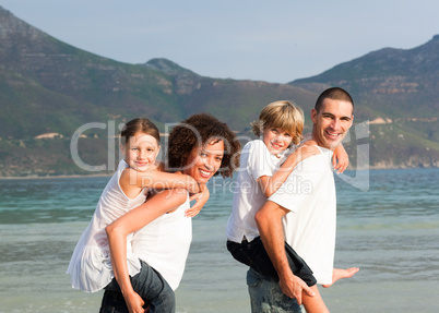 Happy family playing on the beach