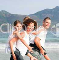 Parents giving two young children piggyback rides