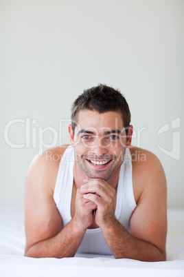 Attractive man lying in bed smiling
