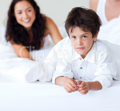 Family playing with his son in bed
