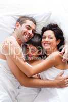 Happy family together in bed