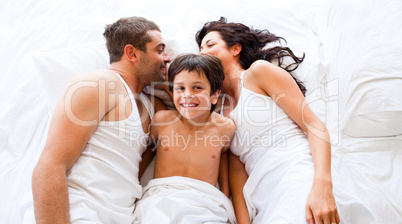 Couple and son lying in bed