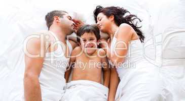 Smiling son with his parents sleeping