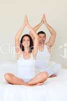 Couple doing exercises on bed