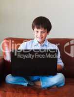 Child playing with his laptop
