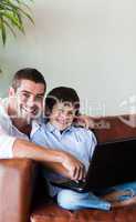 Father and son together with a computer