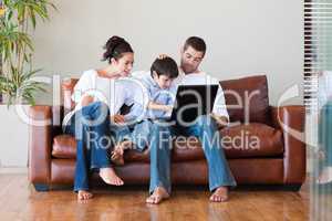 Parents and son playing with a laptop