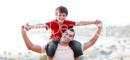 Young man giving child piggyback ride