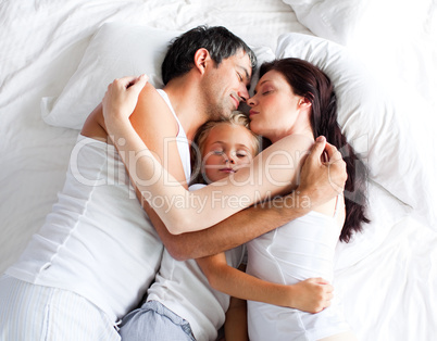 Little gril sleeping on bed with her parents