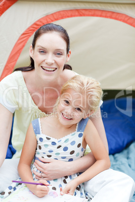 Mother and daughter playing in tent