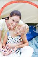 Mother and daughter playing in tent