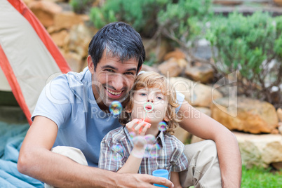 Father and son blowing bubbles