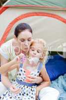 Mother and daughter together in tent