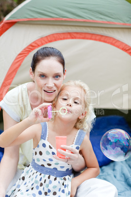 Mother and daughter together in tent