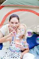 Mother and daughter playing in tent