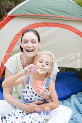Mother and daughter playing with bubbles