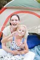 Mother and daughter playing with bubbles