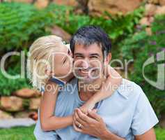 Daughter kissing her father