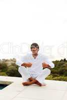 Man doing yoga on the pool with copy-space