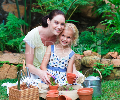Mother and daughter planting in their garden