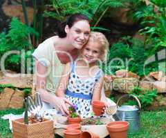 Mother and daughter planting in their garden