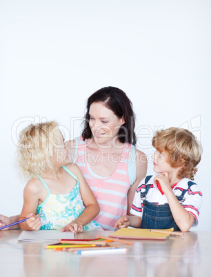 Mother helping her children doing homework