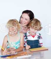 Children doing homework with their mother