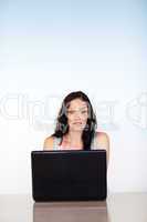 Woman concentrated on her laptop with copy-space