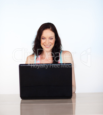 Smiling woman concentrated on her laptop